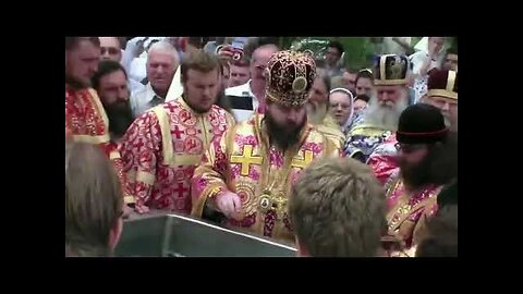 Russian Orthodox Christians drinking holy water from a foot relic of a dead saint
