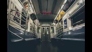 Man wildly spinning around on the subway