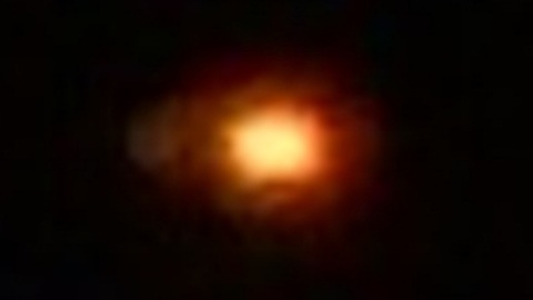 Orange unindentified object hover in the night sky