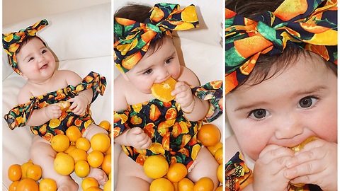 Baby in orange-themed dress eats oranges for the first time