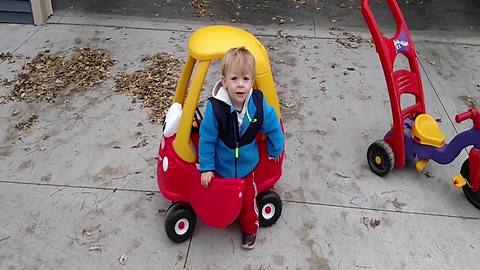 Tot Boy Pretends To Put The Gas In His Toy Car