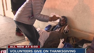 Volunteers give to the homeless on Thanksgiving