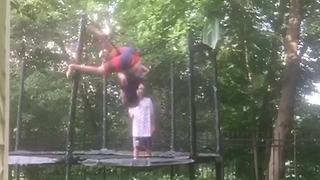 "Two Boys Jump On A Trampoline And One Is Launched Onto The Net"