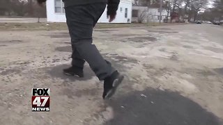 West Michigan boy fixes potholes on his own