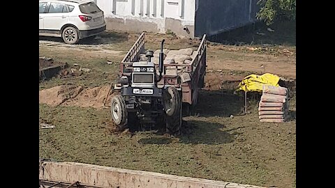 Tractor doing stunts after getting stuck in the mud.