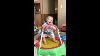 Baby jumping for joy, on little trampoline!