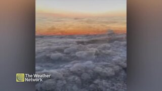 Huge ice-filled waves crash onshore at sunset