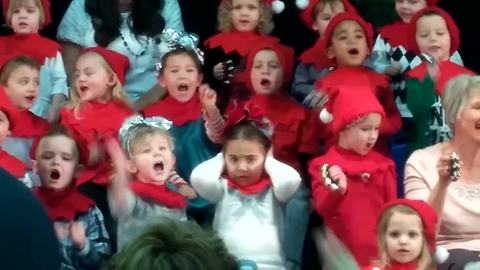 "A Young Girl Covers Her Ears As The School Choir Sings Christmas Carols"