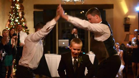 Groom and best friend light up wedding dance floor