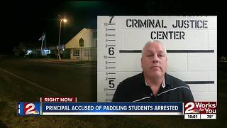 Principal accused of paddling students arrested