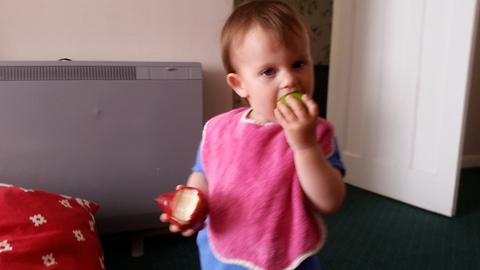 Cute baby eating a lime and a pear!