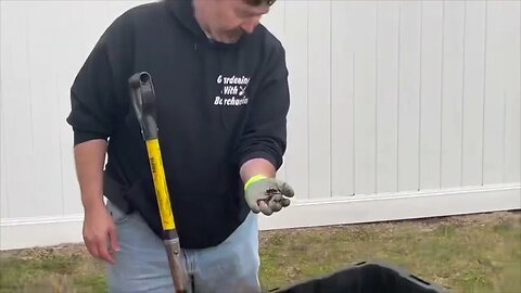 Soil Factory adding compost into a raised garden bed