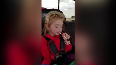 Tot Girl Eats A Lollipop From The Wrong End