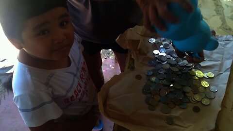 A very happy 6 year old boy breaking his piggy bank for Bicycle.