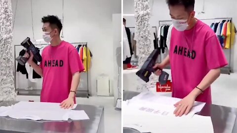 Guy printing t-shirt quickly and manually