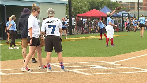 Buffalo police officers and firefighters take part in charity softball game.