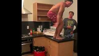 Dude does front-flip onto kitchen floor, acts like it's no big deal