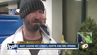 Many choose wet streets, despite shelters opening
