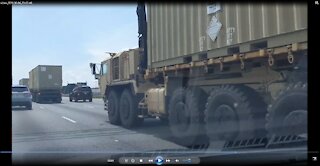 A military convoy of heavy transports hauling shipping containers on I-85 Atlanta