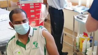 NHRS Lab worker gets his shot