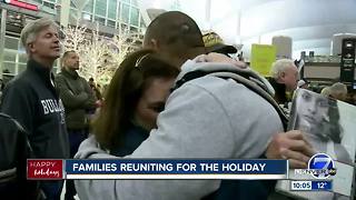 Hugs, kisses and reunions at Denver International Airport on Christmas Eve