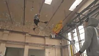 Friends do basketball stunts in abandoned factory