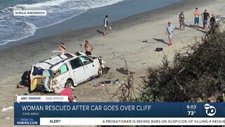 Woman rescued after car goes over cliff