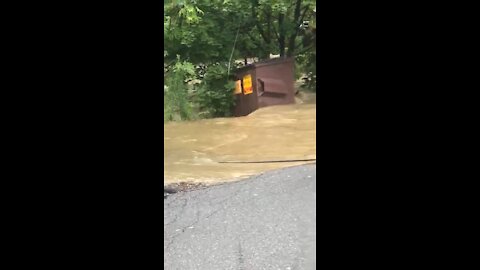 Runaway dumpster floats downstream as as result of Hurricane Isaias