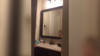 "Boy Sings In Front Of Mirror"