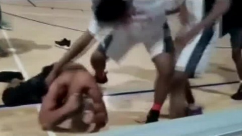 Players fight referee at basketball game
