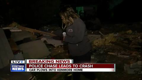Truck plows through two homes after chase