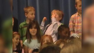 Little Boy Plays Air Guitar During School Concert