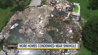 Florida sinkhole draws neighbors checking out progress