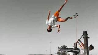 Young athlete performs impressive acrobatic stunt on Moroccan beach