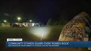 Residents stand guard overnight after racist message painted on Romeo Rock