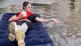 Resident takes advantage of floodwater to relax