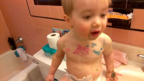 Toddler goes to town on little brother with markers