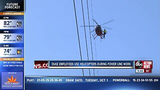 Duke employees use helicopters during power line work