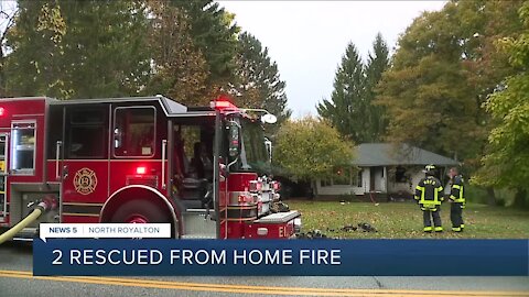 North Royalton firefighters rescue 2 people, dog from house fire