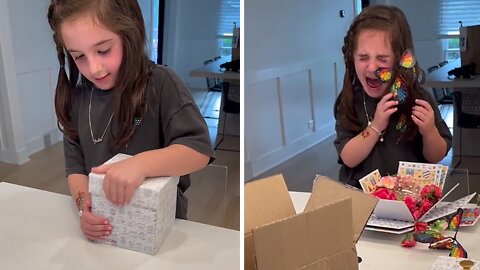 Little girl not too thrilled with exploding butterfly box