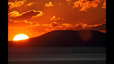 Sunrise. Sonce also appears over the mountains.