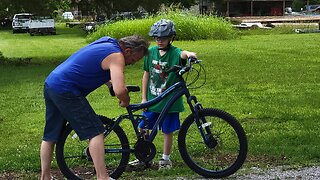 FATHER TRIES TO TEACH HIS SON HOW TO RIDE A BICYCLE