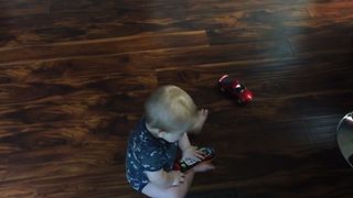 Cute Baby Chases Toy Car Around In Circles