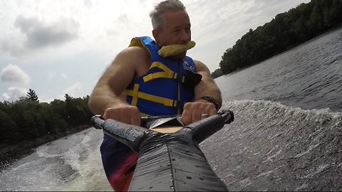 Hungry wake boarder takes unusual snack along for ride