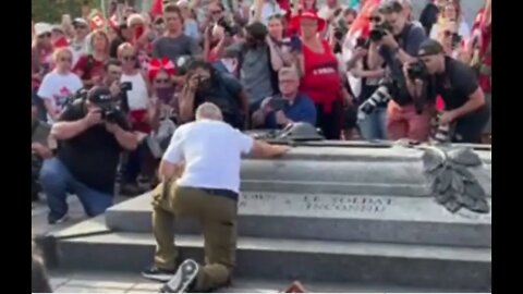 Thousands go silent as James Topp, ending his cross-Canada march, places his hand on the tomb