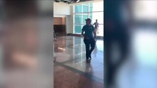 Video shows woman chasing passenger at DIA after threatening employees before punching officer