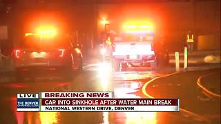 Car falls into sinkhole after water main break