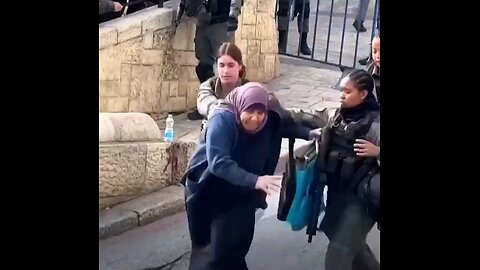 Female IDF soldiers push a Palestinian old lady into a barrier