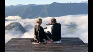 Couple has tea on top of a mountain