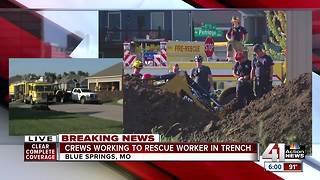 Crews work to rescue worker in trench